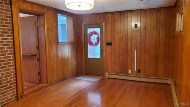 Room with flooring, wood walls