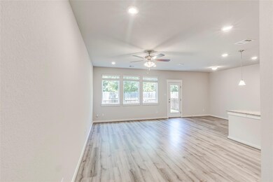 Empty room featuring ceiling fan, light wood-type