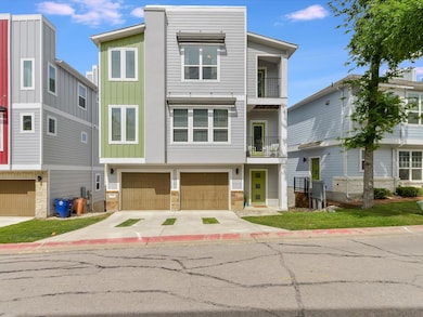 Contemporary home featuring board and batten siding, concrete driveway, a balcony, stone siding, and a garage
