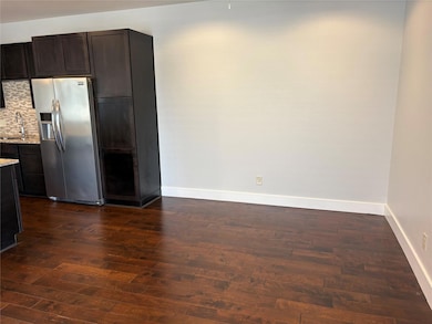 Kitchen with stainless steel refrigerator with ic