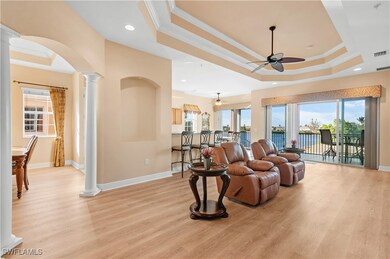 Living room with ornate columns, light wood-type f