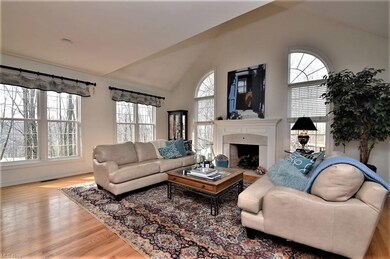 Great room with wood floors, vaulted ceiling and d