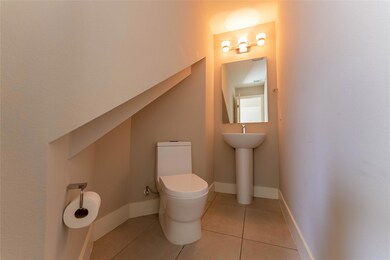 Bathroom featuring toilet and tile patterned floo