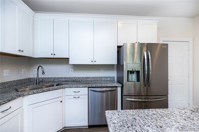 Kitchen with refrigerator, stainless steel dishwas