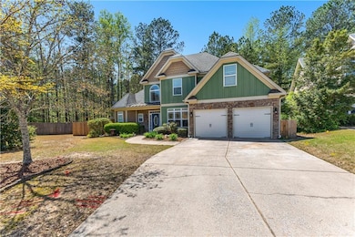Craftsman-style house with concrete driveway, ston