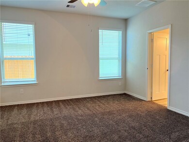 Spare room featuring carpet flooring, a ceiling fa