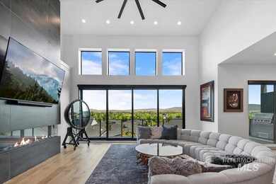 Living area with a high ceiling, a ceiling fan, wood finished floors, a tile fireplace, and recessed lighting
