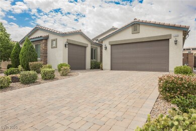 Ranch-style home featuring a tile roof, decorative driveway, stucco siding, and an attached garage