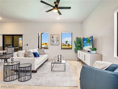 Living area featuring a ceiling fan and recessed l