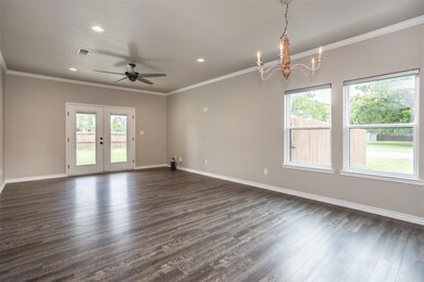 Spare room with crown molding, french doors, dark 