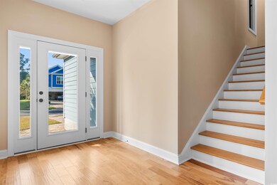 Doorway to outside with light hardwood / wood-styl