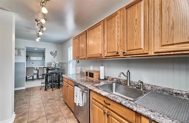 Kitchen has ample cabinets, disposal & dishwasher