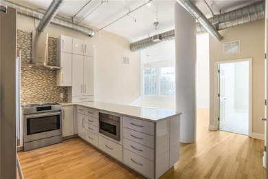 Kitchen with visible vents, wall chimney range hoo