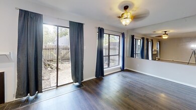 Unfurnished living room with ceiling fan, dark woo