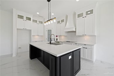 Kitchen featuring premium range hood, light marble finish floors, black electric stovetop, recessed lighting, and tasteful backsplash