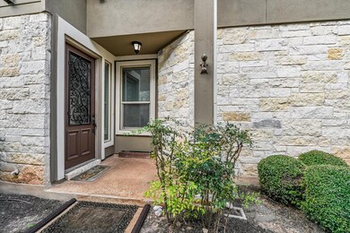 Entrance to property featuring stone siding