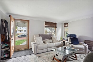 Carpeted living room with crown molding