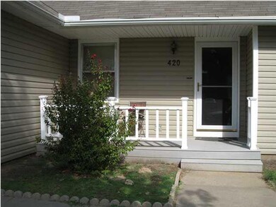 Cute covered front composite porch with railing an