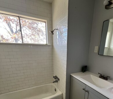 Full bathroom with shower / washtub combination and vanity