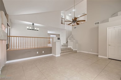 Empty room featuring stairs, ceiling fan with nota