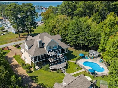 Drone / aerial view of a pool area and a large body of water