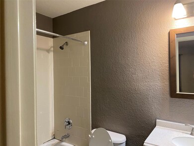 Full bathroom featuring toilet, tiled shower / bat
