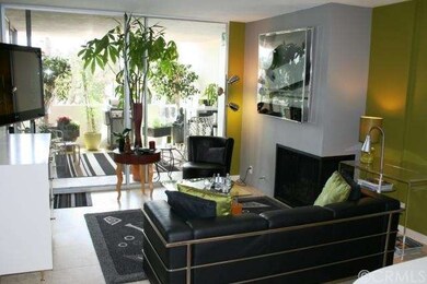 Living room with fireplace and adjacent lanai allo