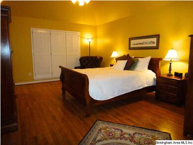 The large master bedroom has room for a sitting ar