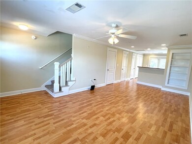 Unfurnished living room with crown molding, light