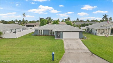View of front of property with a garage and a front yard