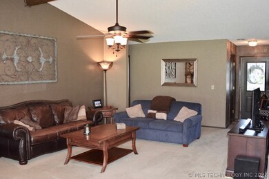 Spacious Living Room with a Beam and Vaulted Ceili