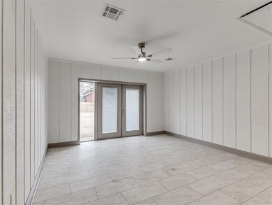 Spare room featuring french doors and ceiling fan