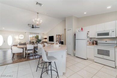Kitchen with white appliances, open floor plan, a