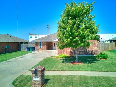 View of front facade with driveway and brick siding