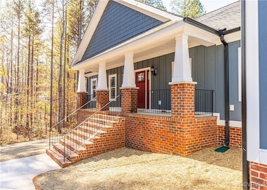 View of front of home featuring brick siding, a po
