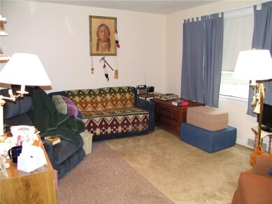 Spacious living room with hardwood floors under th