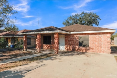 View of front of home with brick siding and roof with shingles