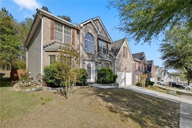 Traditional home with a garage, concrete driveway, a residential view, and a front yard