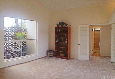 Spacious living room with high ceilings, lots of n