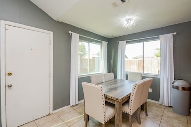 Bright and inviting dining area with lots of natural light, perfect for gatherings.