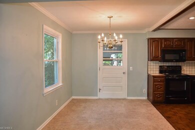 Dining room with crown molding and access to the s