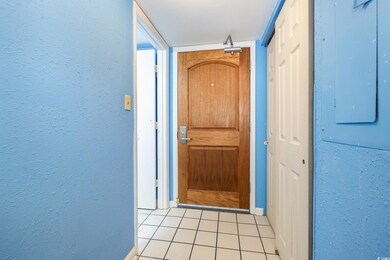 View of exterior entry with electric panel