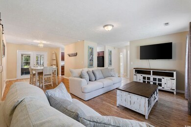 Living room with a textured ceiling, wood-type flo