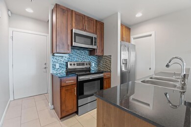 Kitchen with a sink, tasteful backsplash, dark st