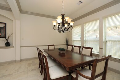 MILLWORK DETAILS:  Double crown molding and a chair rail provide interest in this pretty formal dining room.