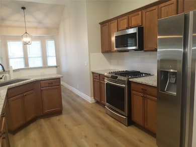 Kitchen with stainless steel appliances, a sink, 