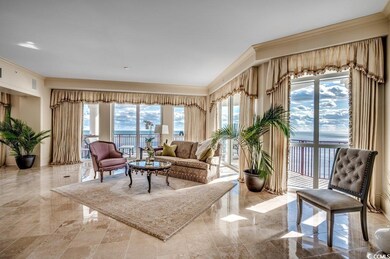 Living room with crown molding and a water view