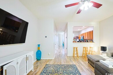 Living room featuring light wood-style floors and a ceiling fan