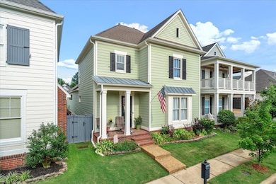 View of property featuring a balcony and a front yard