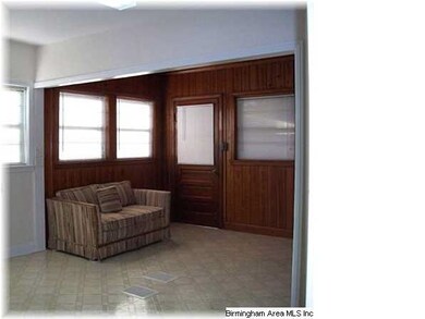 Den with an open view of kitchen